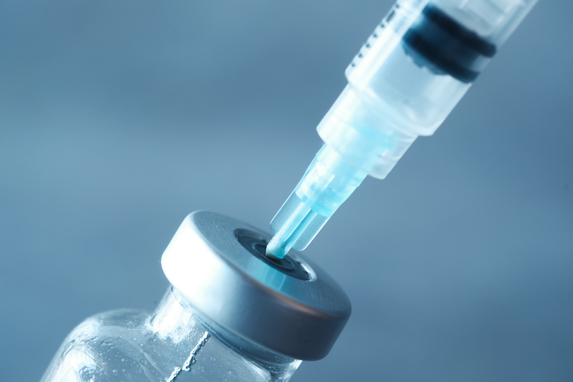 glass vial and syringe on black background